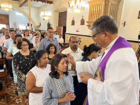 Rev. Fr. Walter De Sa, Parish Priest of Immaculate Conception Church, Panaji, administers ashes to devotees, marking the commencement of the Lenten season.